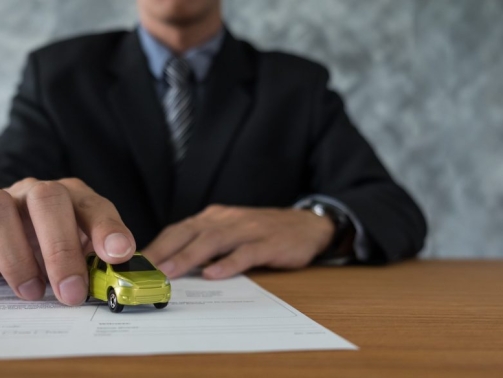 transportation and ownership concept - customer and salesman with car key