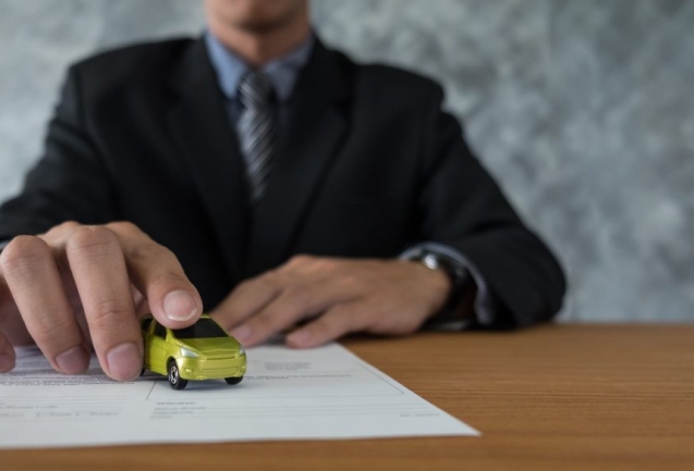 transportation and ownership concept - customer and salesman with car key